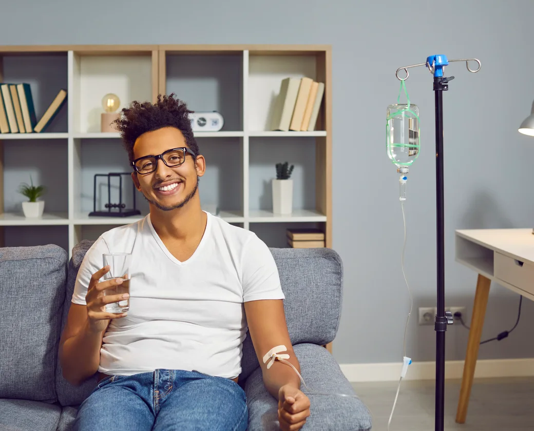 Patient smiling while receiving IV hydration